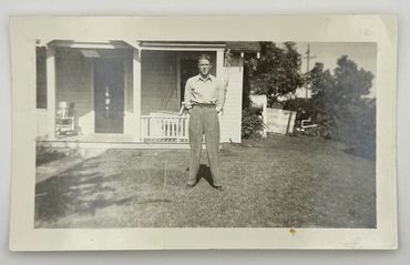 Man standing in front of house.