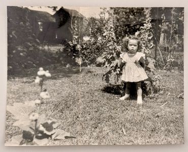 A little girl in the garden.