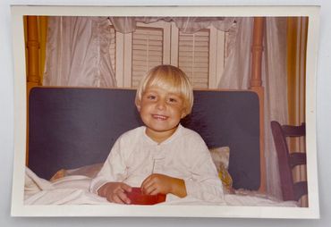 A little girl is smiling at the camera.