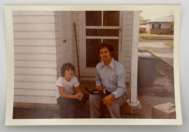 Father and son are sitting on a back porch.