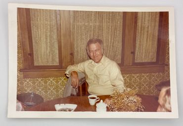 A man sitting at a table smiling.