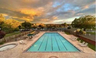 a swimming pool at sunset