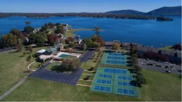 a tennis court near a lake