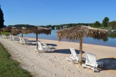 a beach with chairs and umbrellas