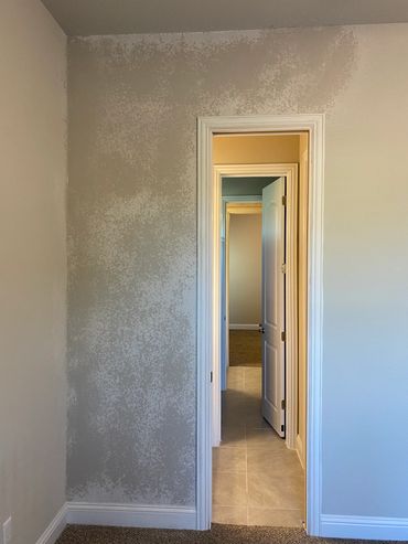 Open door reveals a hallway with beige walls and tiled floor.