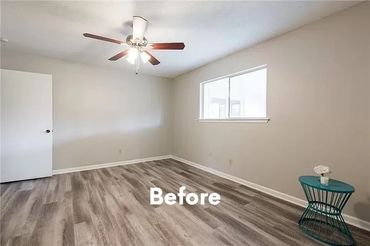 Empty room with wood flooring, beige walls, and ceiling fan.