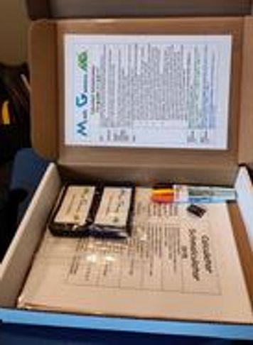 A wooden game box with game pieces inside.