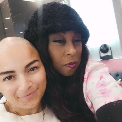 Two women posing closely for a selfie indoors.