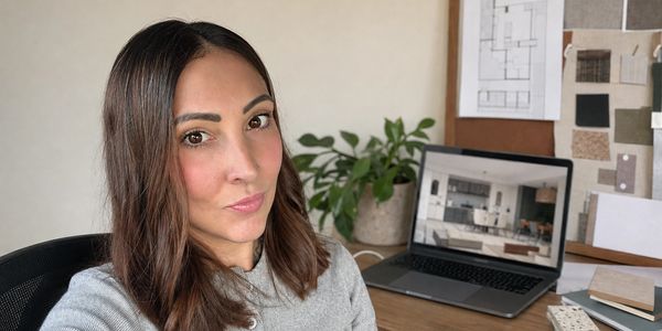 Woman taking a selfie in a home office setting.