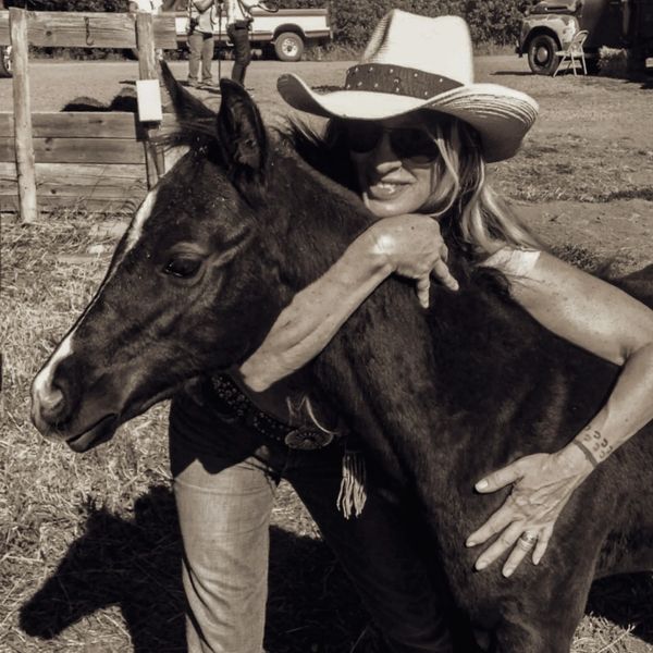 Photographer Dona Bollard with a yearling horse.