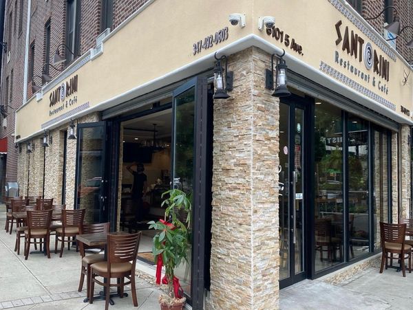 Corner cafe with outdoor seating and glass doors.