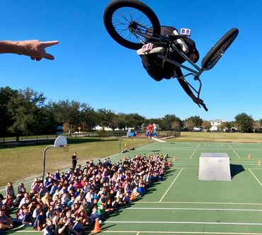 Dylan Carter  performing for students at one of BMX Trickstars educational school show.