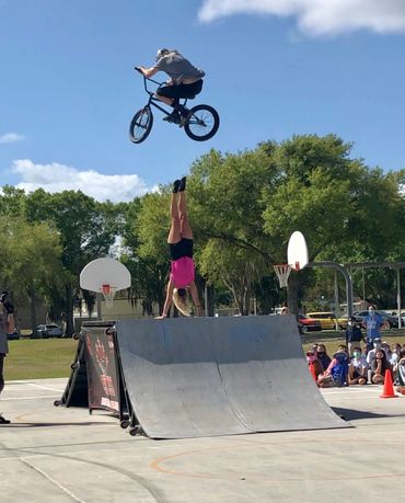 Riley Jordan jumping over the coach doing a handstand at one of our local BMX school assemblies.