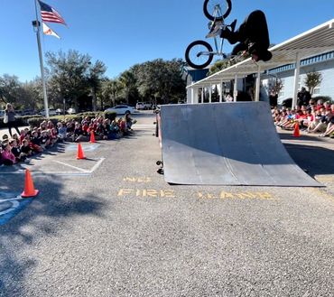 Dylan Carter going upside down in one of our educational BMX stunt shows at a local elementary schoo