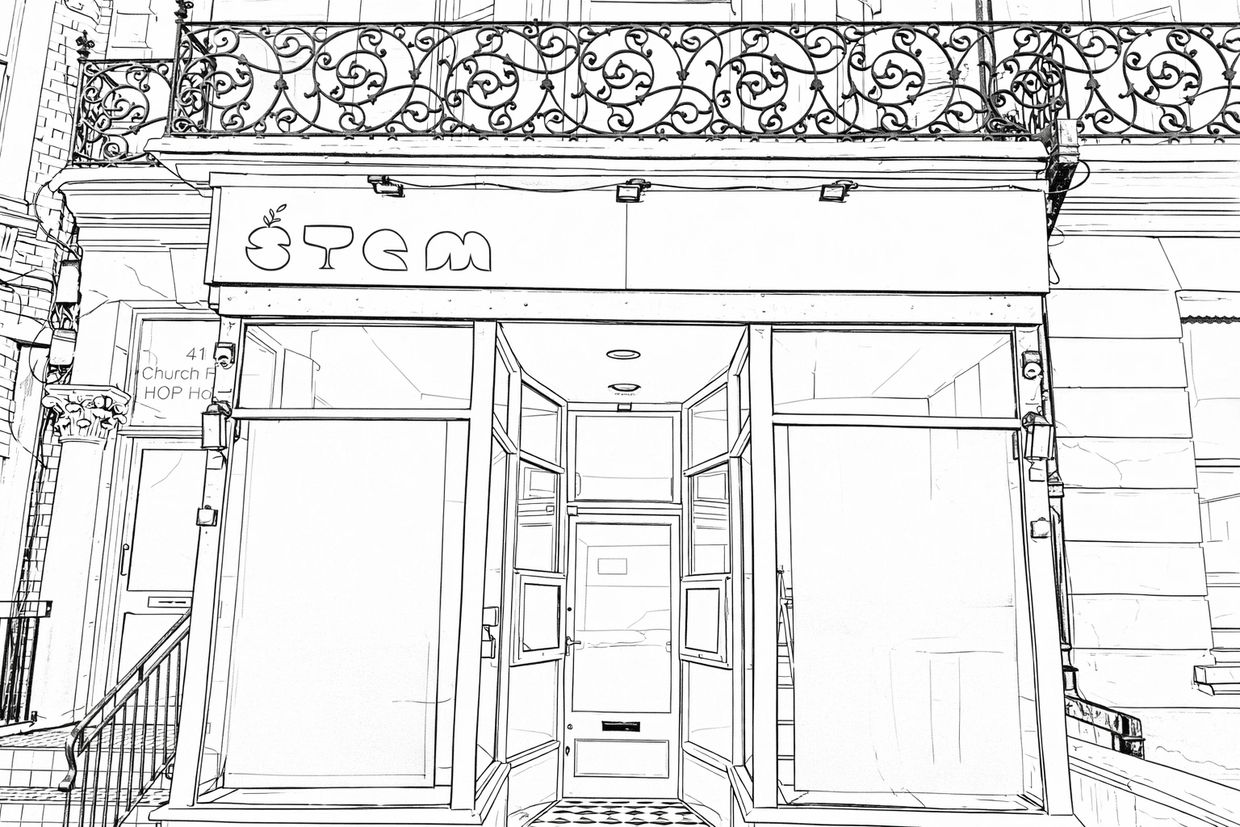 Front view of a storefront with ornate balcony railings above.