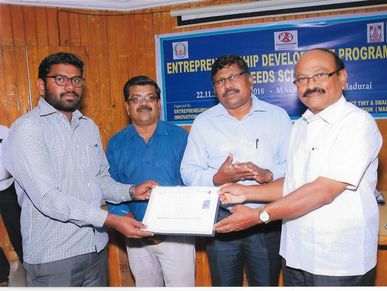 Four men at a certificate presentation event.