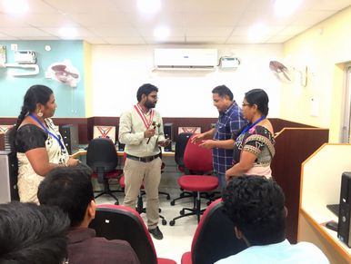Four people having a discussion in an office.