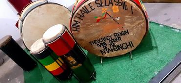 Traditional Ethiopian drums with inscriptions honoring Haile Selassie I and the Nyahbinghi order.