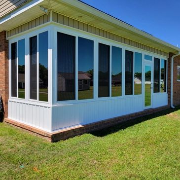 Picture of the outside of a sun room that was tinted with reflective mirror film