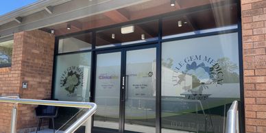 Entrance of a medical center with glass doors and signage.