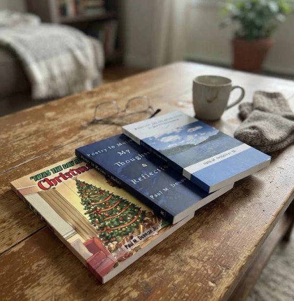 Books, glasses, a cup, and gloves on a wooden table.