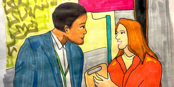 A man and a woman talking to each other on a city street
