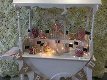 Candy cart with jars, decorations and sweets