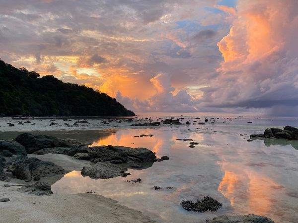 The rising sun and pastel skies create a surreal scene at Mu Ko Surin Islands