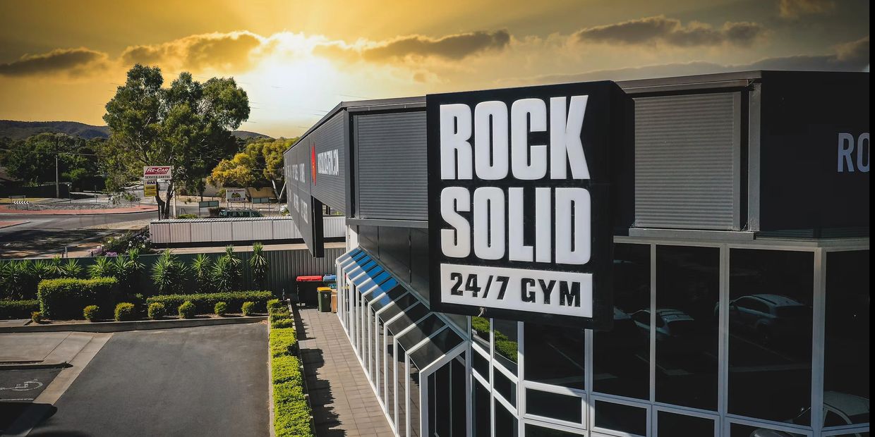 Exterior of the Rock Solid 24/7 gym during sunset.