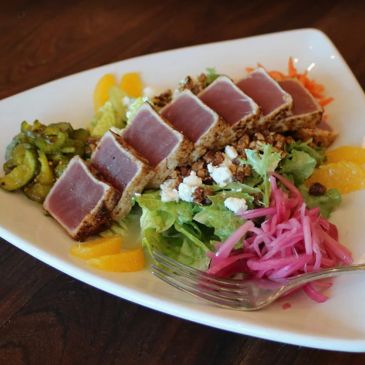 Seared tuna salad with mixed greens and pickled vegetables.