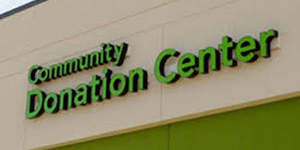 Sign reading 'Community Donation Center' on a building.