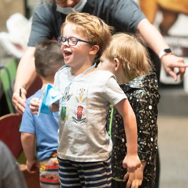 Boy at VBS, jumping for joy.