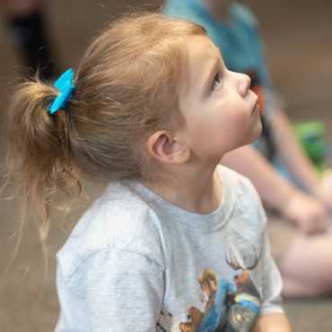Girl listening in kindergarten.