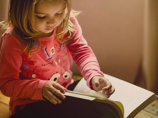 Girl learning how to read.