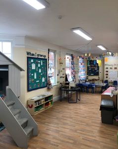 A brightly lit classroom with colorful decorations and seating arrangements.