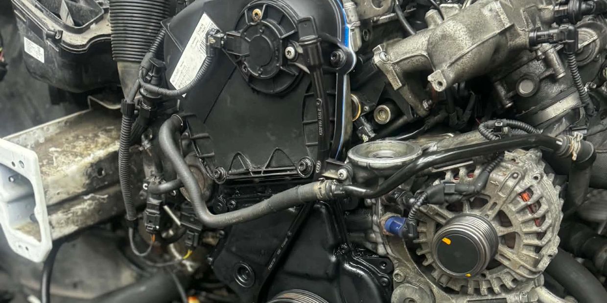 Close-up of a car engine with various mechanical components and wiring.