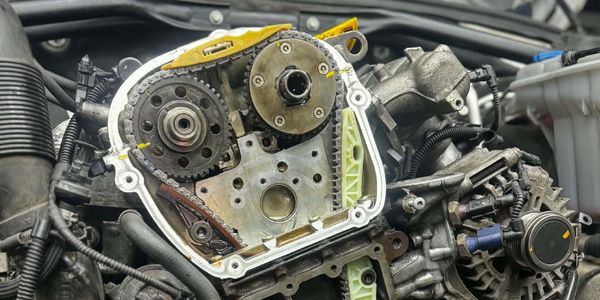Close-up of a car engine's timing chain and gears.