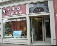 Exterior of Village Studios, a film and craft shop with an open door.