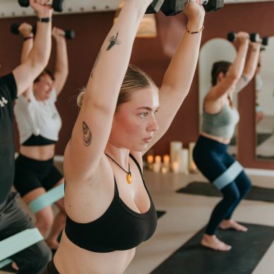 Group workout session lifting dumbbells.