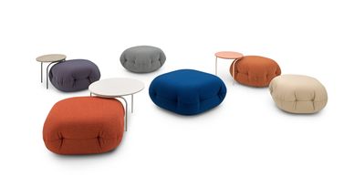 Colorful poufs and small side tables arranged in a modern, minimalist style.