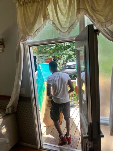 Professional  movers carry dressers outside