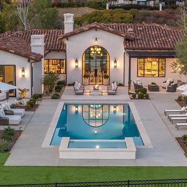 Luxury house with a swimming pool at sunset.