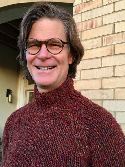 Tod happy and smiling in a new hand-knit sweater 