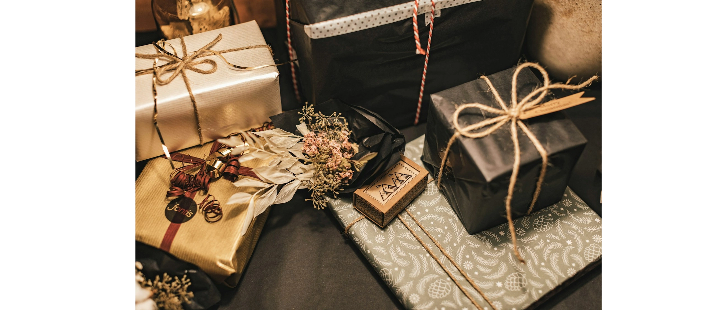 Elegantly wrapped gifts with natural twine and dried floral decorations.