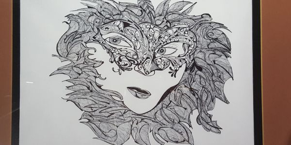 Intricate face surrounded by leaf-like patterns.