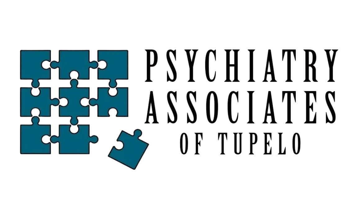 Logo of Psychiatry Associates of Tupelo with blue puzzle pieces and text.