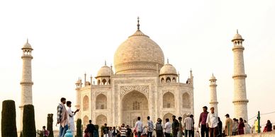 The Taj Mahal with tourists around it.