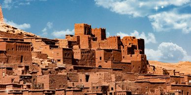 Old mud-brick village under a bright sky.