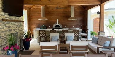 Cozy outdoor seating area with stone oven and wooden accents.