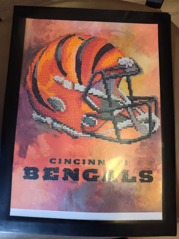 A beaded Cincinnati Bengals football helmet artwork.